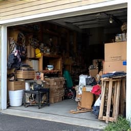 Cluttered garage before cleanout in Marana