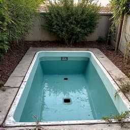 Before image of an old spa located in a tight backyard space in Marana, requiring careful removal.