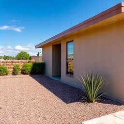 Residential home exterior looking pristine after professional cactus and yard waste removal. Residential yard cleanup, exterior maintenance, trash hauling.